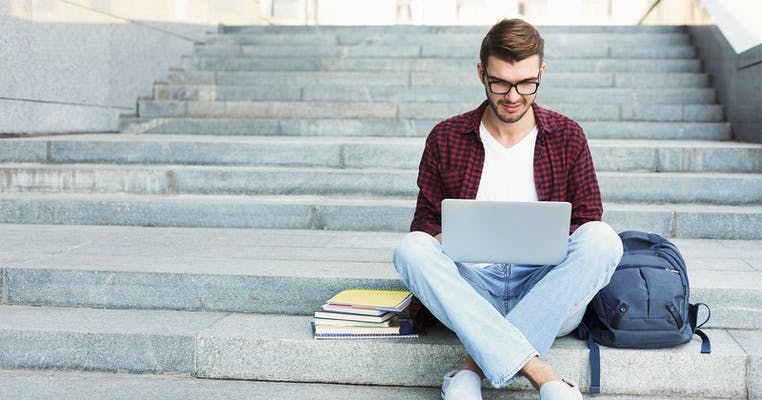 Person von Yallo am Laptop